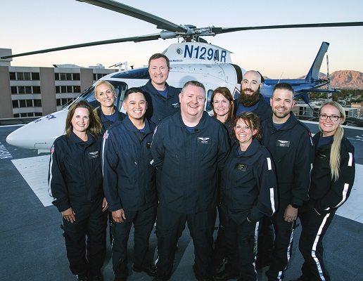 Critical Care Transport team standing in front of a helicopter